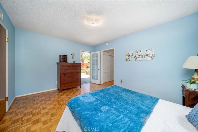bedroom featuring baseboards and a textured ceiling