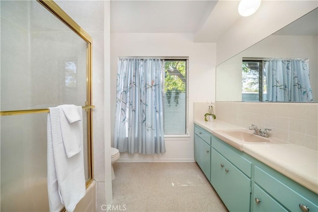 full bathroom with toilet, tasteful backsplash, vanity, and combined bath / shower with glass door