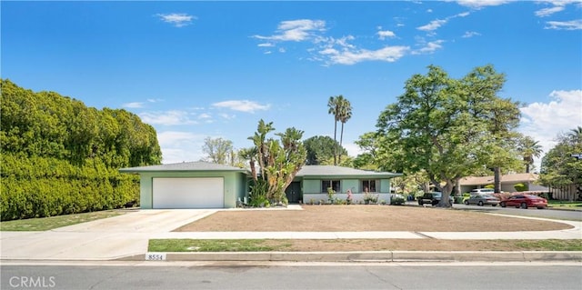 single story home featuring driveway, a garage, and stucco siding