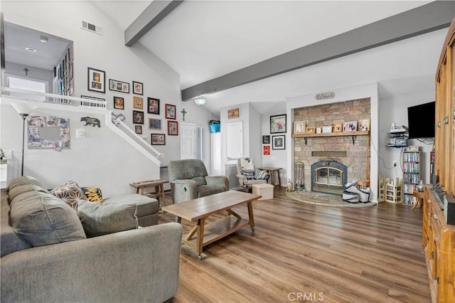 1799 Betty St, Wrightwood, CA 92397 - living area with light wood finished floors, lofted ceiling with beams, visible vents, and a fireplace