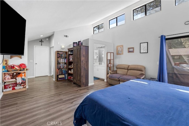 1799 Betty St, Wrightwood, CA 92397 - bedroom with high vaulted ceiling, connected bathroom, visible vents, wood finished floors, and baseboards