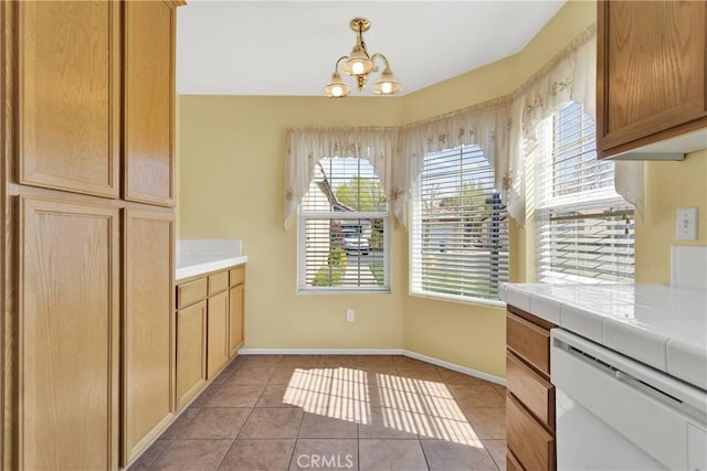 19071 Stoddard Way, Apple Valley, CA 92308 - kitchen featuring white dishwasher, tile counters, a chandelier, and light tile patterned floors