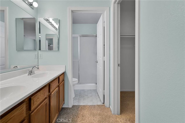 19071 Stoddard Way, Apple Valley, CA 92308 - bathroom featuring double vanity, a shower with door, and a walk in closet