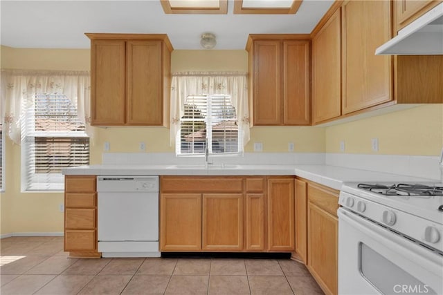19071 Stoddard Way, Apple Valley, CA 92308 - kitchen featuring white appliances, under cabinet range hood, light tile patterned flooring, and tile countertops