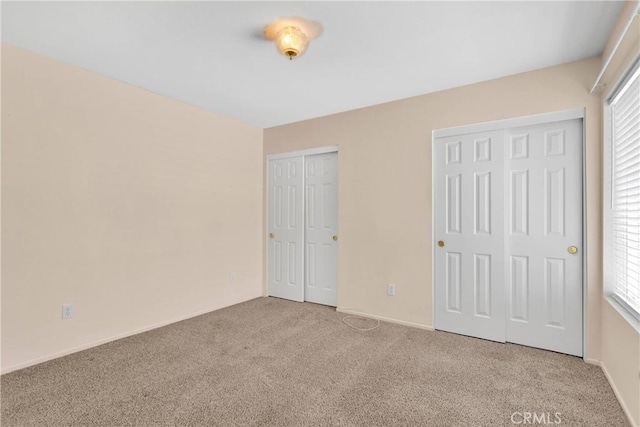 19071 Stoddard Way, Apple Valley, CA 92308 - unfurnished bedroom with two closets, carpet, and multiple windows