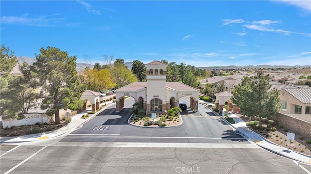 19071 Stoddard Way, Apple Valley, CA 92308 - view of asphalt street with curbs, a mountain view, sidewalks, and a gated entry