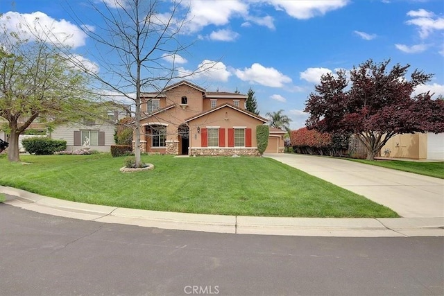 view of front of house with a front yard, concrete driveway, stone siding, and stucco siding