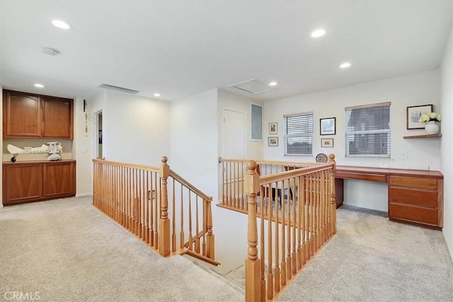 interior space featuring recessed lighting, an upstairs landing, and light colored carpet