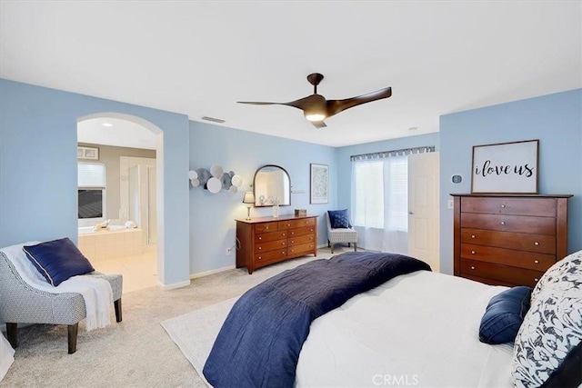 bedroom featuring arched walkways, a ceiling fan, visible vents, carpet flooring, and baseboards