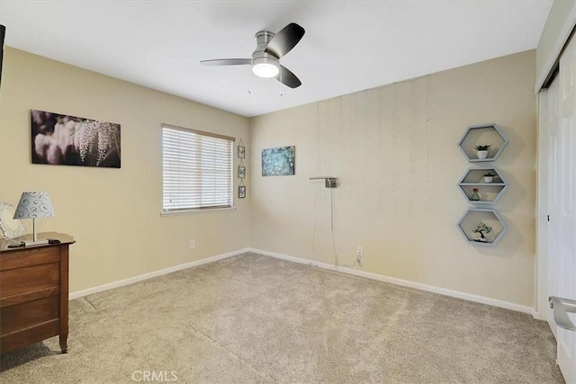 bedroom featuring a closet, baseboards, a ceiling fan, and carpet floors
