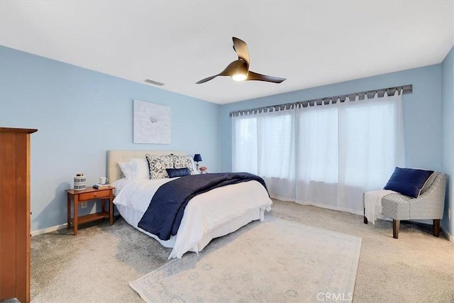 bedroom featuring visible vents, baseboards, carpet flooring, and ceiling fan