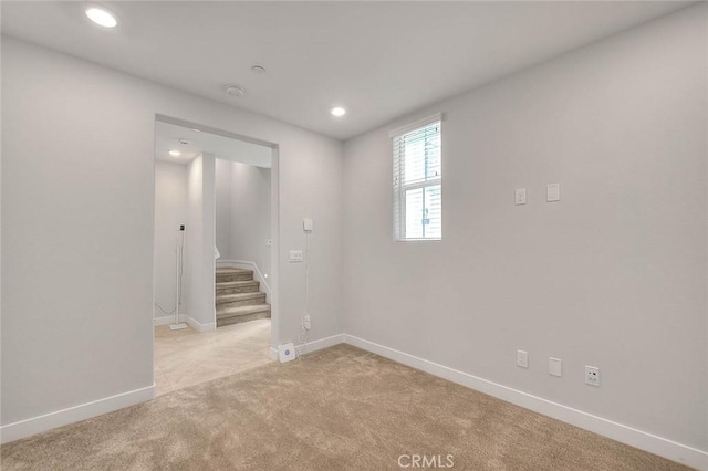 6 Crown Point Dr, Rancho Mission Viejo, CA 92694 - spare room featuring light colored carpet, baseboards, stairway, and recessed lighting