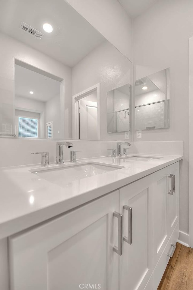 6 Crown Point Dr, Rancho Mission Viejo, CA 92694 - full bath featuring a sink, visible vents, double vanity, and wood finished floors