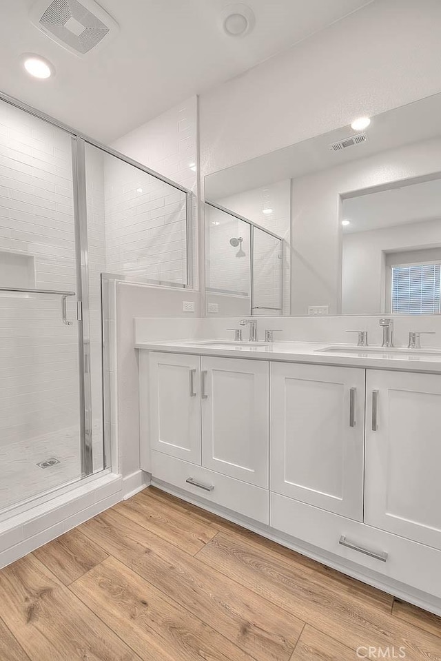 6 Crown Point Dr, Rancho Mission Viejo, CA 92694 - full bathroom with a stall shower, wood finished floors, double vanity, and a sink
