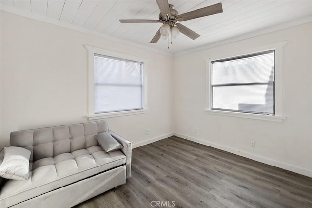 unfurnished room featuring crown molding, baseboards, a ceiling fan, and wood finished floors