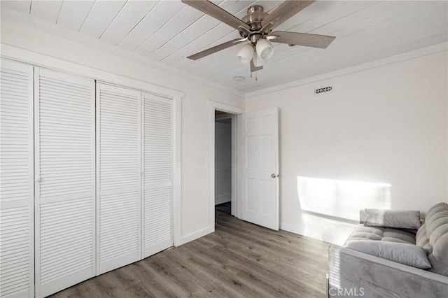 unfurnished room with visible vents, baseboards, ceiling fan, crown molding, and wood finished floors