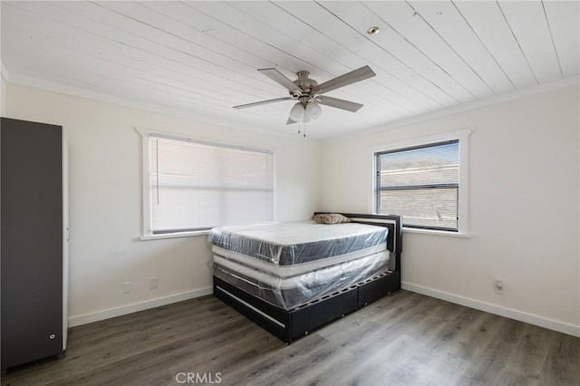bedroom featuring ceiling fan, baseboards, ornamental molding, and wood finished floors