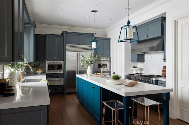 28 Old Course Dr, Newport Beach, CA 92660 - kitchen featuring built in appliances, under cabinet range hood, light countertops, blue cabinets, and crown molding