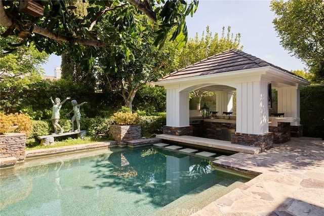 pool with a gazebo and a patio