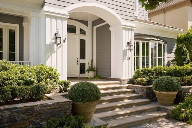 property entrance featuring a porch and board and batten siding