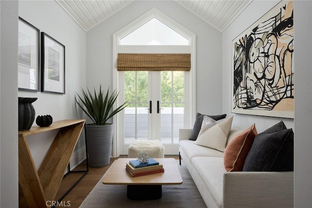 living area with lofted ceiling, french doors, and wood finished floors