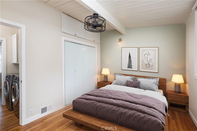 1503 Calle Sacramento, San Clemente, CA 92672 - bedroom with washer and dryer, beamed ceiling, baseboards, wood finished floors, and a closet