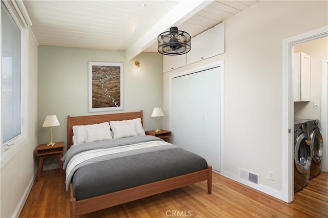 1503 Calle Sacramento, San Clemente, CA 92672 - bedroom with washing machine and clothes dryer, wood finished floors, baseboards, beamed ceiling, and a closet