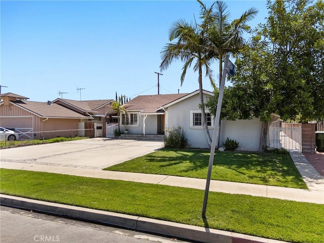 ranch-style house featuring a front yard, fence, a gate, and stucco siding