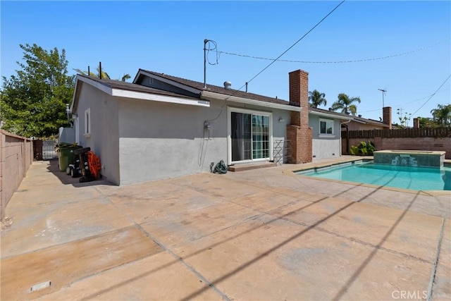 view of pool with a patio, a fenced backyard, and a pool with connected hot tub