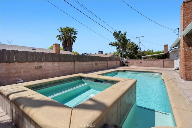 view of pool with a fenced in pool, an in ground hot tub, and a fenced backyard