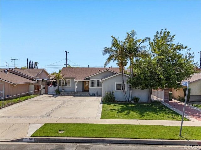 single story home featuring stucco siding, fence, and a front lawn