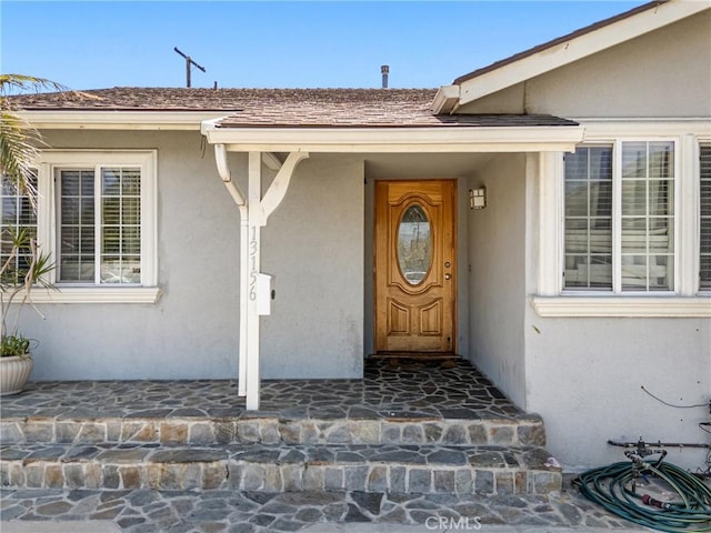 entrance to property with stucco siding