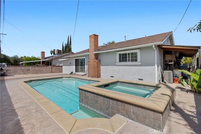 view of swimming pool with a fenced in pool, a patio area, and an in ground hot tub