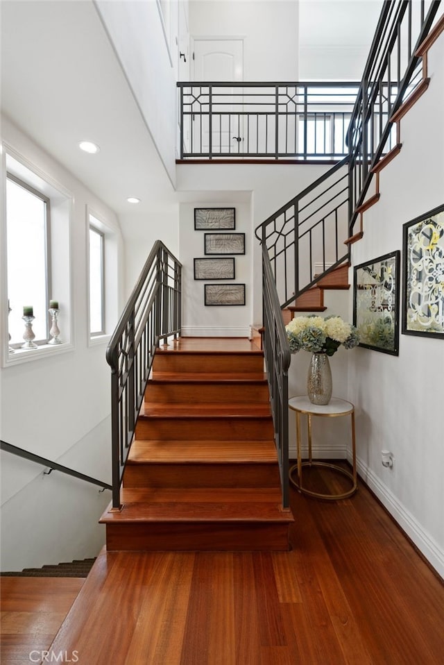 619 10th St, Hermosa Beach, CA 90254 - stairs with a towering ceiling, wood finished floors, baseboards, and recessed lighting