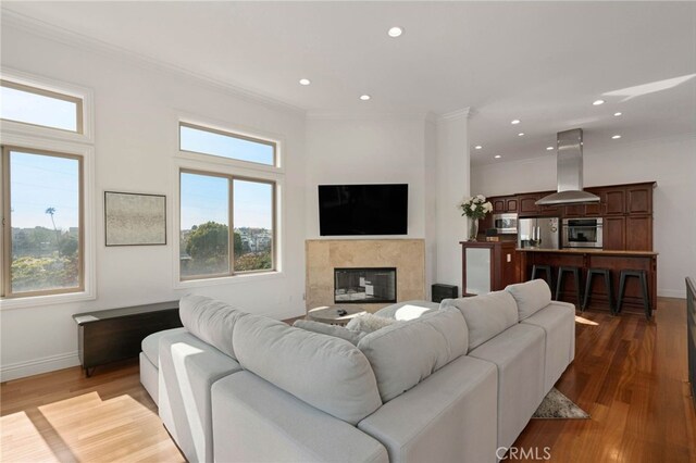 619 10th St, Hermosa Beach, CA 90254 - living room featuring baseboards, recessed lighting, crown molding, wood finished floors, and a premium fireplace