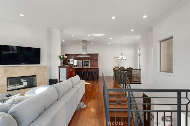 619 10th St, Hermosa Beach, CA 90254 - living area with crown molding, wood finished floors, a fireplace, and recessed lighting