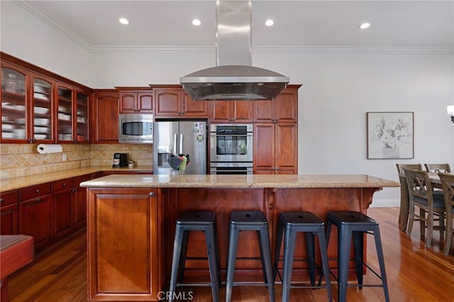619 10th St, Hermosa Beach, CA 90254 - kitchen with glass insert cabinets, dark wood-style flooring, stainless steel appliances, island range hood, and decorative backsplash