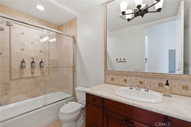 619 10th St, Hermosa Beach, CA 90254 - bathroom with vanity, a chandelier, toilet, combined bath / shower with glass door, and decorative backsplash