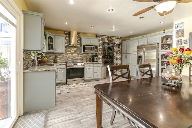 610 Woodington Dr, Lancaster, CA 93535 - kitchen with stainless steel appliances, gray cabinets, wall chimney range hood, a sink, and recessed lighting