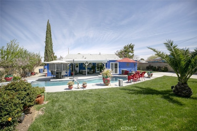 610 Woodington Dr, Lancaster, CA 93535 - rear view of property with an outdoor pool, a yard, a patio, and an outdoor living space
