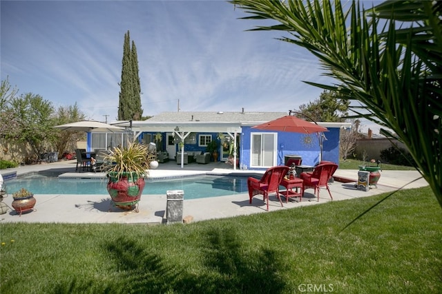 610 Woodington Dr, Lancaster, CA 93535 - swimming pool featuring a lawn, a patio area, and an outdoor structure