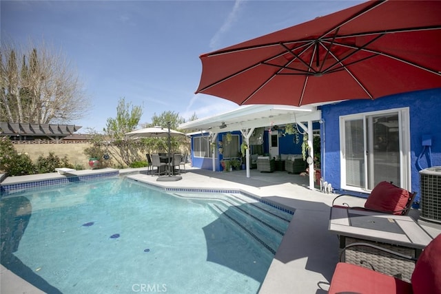 610 Woodington Dr, Lancaster, CA 93535 - view of pool with outdoor lounge area, a patio area, a fenced backyard, central AC, and outdoor dining space