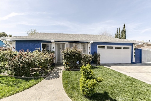610 Woodington Dr, Lancaster, CA 93535 - single story home with an attached garage, concrete driveway, stucco siding, a shingled roof, and a front lawn