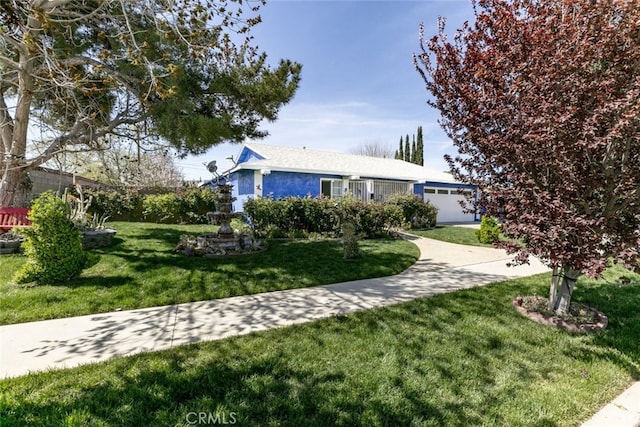 610 Woodington Dr, Lancaster, CA 93535 - ranch-style home featuring a front lawn, a garage, and stucco siding