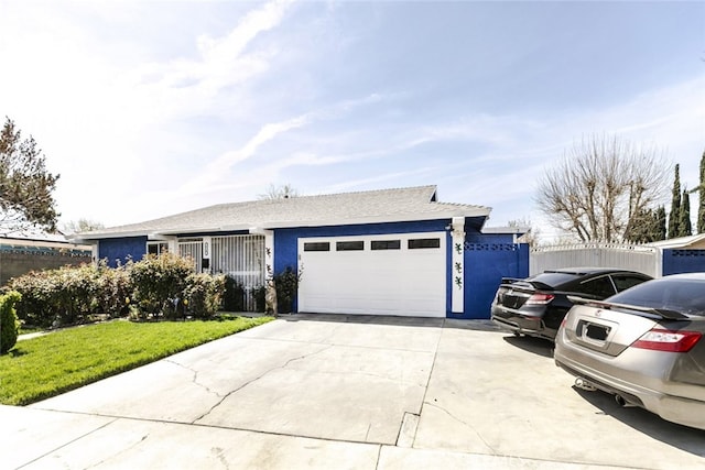 610 Woodington Dr, Lancaster, CA 93535 - single story home with an attached garage, concrete driveway, stucco siding, and a front yard
