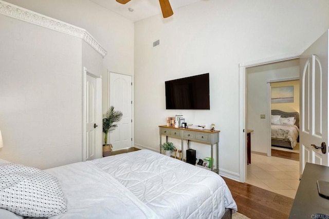 11558 Creek Rd, Poway, CA 92064 - bedroom with wood finished floors, a towering ceiling, and a ceiling fan