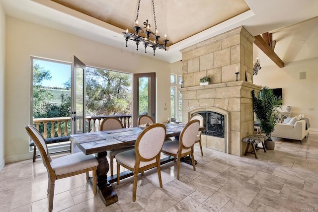 11558 Creek Rd, Poway, CA 92064 - dining room with a raised ceiling, a chandelier, a tile fireplace, and a towering ceiling