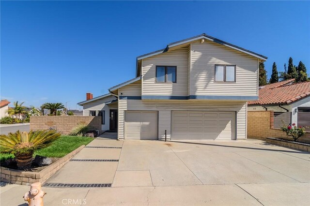 7191 Slater Ave, Huntington Beach, CA 92647 - traditional home with an attached garage, driveway, and fence