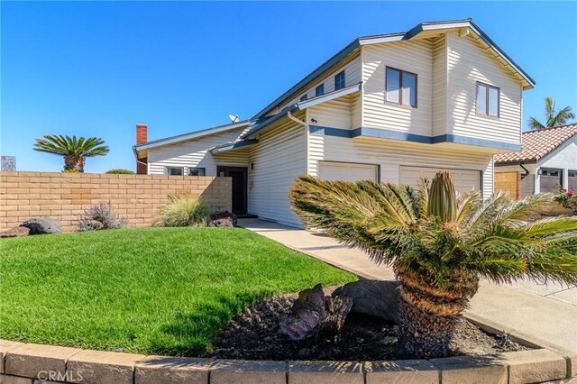 7191 Slater Ave, Huntington Beach, CA 92647 - view of front of property with a garage, fence, and a front lawn