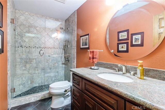 7191 Slater Ave, Huntington Beach, CA 92647 - full bath featuring toilet, a stall shower, vanity, and tile patterned flooring